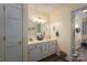 Well-lit bathroom with a double sink vanity, decorative accents, and wood-look flooring at 112 Ocean Dr, Shelby, NC 28152