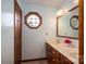 This bathroom offers a double vanity, octagon window, and wood door at 112 Ocean Dr, Shelby, NC 28152