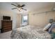 Cozy bedroom with a patterned bedspread, ceiling fan, and a charming view from the window at 112 Ocean Dr, Shelby, NC 28152