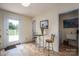 Cozy dining area with a glass-top table, bar stools, and an access door to the backyard at 112 Ocean Dr, Shelby, NC 28152