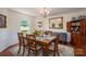 Bright dining room with wood table, six chairs, chandelier, wainscoting, and large window at 112 Ocean Dr, Shelby, NC 28152