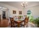 Dining room features a wood table, six chairs, and a window with backyard view at 112 Ocean Dr, Shelby, NC 28152