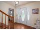 Foyer featuring hardwood floors, staircase, light fixture, and front door with decorative glass at 112 Ocean Dr, Shelby, NC 28152