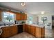 Bright kitchen featuring wooden cabinets, a double sink, and an adjacent dining area with natural light at 112 Ocean Dr, Shelby, NC 28152