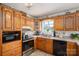Traditional kitchen with wooden cabinetry, stainless steel appliances, and a cozy, decorative ambiance at 112 Ocean Dr, Shelby, NC 28152