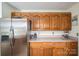 Kitchen featuring wood cabinets, stainless steel refrigerator, and light countertops at 112 Ocean Dr, Shelby, NC 28152