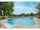 Sparkling in-ground pool with concrete surround, set against lush green lawn and mature trees at 112 Ocean Dr, Shelby, NC 28152