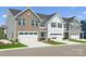 Charming townhome showcasing a well-maintained lawn and attached garage, blending style with convenience at 1229 Margo Mannor Dr, Fort Mill, SC 29708
