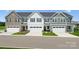 Beautiful townhome exterior with attached garages, manicured lawn, and classic architectural details at 1229 Margo Mannor Dr, Fort Mill, SC 29708