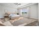 Tranquil main bedroom with a tray ceiling, a comfortable bed, and large windows at 1229 Margo Mannor Dr, Fort Mill, SC 29708