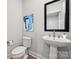 Modern powder room with a sleek pedestal sink, framed mirror, and stylish artwork at 1229 Margo Mannor Dr, Fort Mill, SC 29708