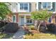 Charming townhome featuring a welcoming covered porch and professionally landscaped front yard at 127 Walnut Cove Dr # D, Mooresville, NC 28117