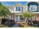 Charming townhome with brick accents, a covered porch, and well-maintained landscaping at 127 Walnut Cove Dr # D, Mooresville, NC 28117