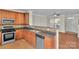Well-lit kitchen featuring tile backsplash, stainless steel appliances and open layout at 127 Walnut Cove Dr # D, Mooresville, NC 28117