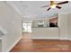 Open-concept living room featuring hardwood floors, modern ceiling fan, and neutral wall color scheme at 127 Walnut Cove Dr # D, Mooresville, NC 28117