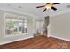 Bright living room with a large window, hardwood floors, and staircase at 127 Walnut Cove Dr # D, Mooresville, NC 28117