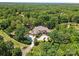 Expansive aerial view of a luxury home surrounded by lush greenery and a circular driveway at 1405 Saratoga Woods Dr, Waxhaw, NC 28173
