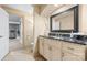 Elegant bathroom with a dark marble countertop vanity and a doorway leading to an exercise room at 1405 Saratoga Woods Dr, Waxhaw, NC 28173