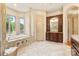 Bright primary bathroom features a soaking tub, large vanity, and window overlooking the yard at 1405 Saratoga Woods Dr, Waxhaw, NC 28173