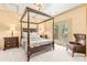 Primary bedroom featuring a canopy bed, access to balcony, carpet, and neutral paint at 1405 Saratoga Woods Dr, Waxhaw, NC 28173