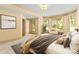 Bright bedroom featuring large windows, neutral tones, and a cozy seating area by the natural light at 1405 Saratoga Woods Dr, Waxhaw, NC 28173