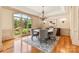 Charming dining room with a large window, chandelier, and seating for six around a round table at 1405 Saratoga Woods Dr, Waxhaw, NC 28173