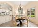 Cozy dining room with a round table, neutral colors, natural light, and a view of the kitchen at 1405 Saratoga Woods Dr, Waxhaw, NC 28173