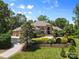 Stunning brick home with manicured landscaping, a circular driveway, and an attached three-car garage at 1405 Saratoga Woods Dr, Waxhaw, NC 28173