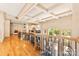Hallway with hardwood flooring and ornate iron banisters, overlooking the living room and front entrance at 1405 Saratoga Woods Dr, Waxhaw, NC 28173