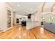 Open-concept kitchen with hardwood floors and stainless steel appliances provides seamless flow for modern living at 1405 Saratoga Woods Dr, Waxhaw, NC 28173
