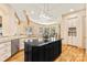 The modern kitchen features stainless appliances, a center island, granite countertops, and ample counter space at 1405 Saratoga Woods Dr, Waxhaw, NC 28173