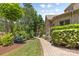 A brick path meanders through lush landscaping, showcasing the property's curb appeal and inviting entrance at 1405 Saratoga Woods Dr, Waxhaw, NC 28173