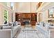 Elegant living room with hardwood floors, a fireplace, built-in shelving, and ample natural light at 1405 Saratoga Woods Dr, Waxhaw, NC 28173