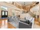 Open-concept living room showcasing a grand staircase, soaring ceilings, and comfortable seating arrangements at 1405 Saratoga Woods Dr, Waxhaw, NC 28173