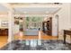 Spacious living area featuring hardwood floors, a wall of windows, and seamless flow into other living spaces at 1405 Saratoga Woods Dr, Waxhaw, NC 28173