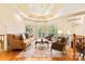 Cozy living room with beautiful hardwood floors, a trey ceiling with decorative paint, and many windows at 1405 Saratoga Woods Dr, Waxhaw, NC 28173