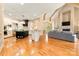 Open-concept living space showcasing kitchen, living, and dining areas with hardwood floors and natural light at 1405 Saratoga Woods Dr, Waxhaw, NC 28173