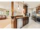 Wet bar with stainless steel dishwasher, granite countertops, and bar stool seating with pendant lighting at 1405 Saratoga Woods Dr, Waxhaw, NC 28173
