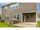 A view of the backyard with a brick patio and outdoor grilling station at 150 W Morehouse Ave, Mooresville, NC 28117