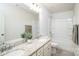 Modern bathroom with double sinks, granite countertops, and combined tub/shower at 150 W Morehouse Ave, Mooresville, NC 28117