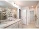 Bright bathroom featuring a double vanity with granite countertops, a large mirror, and walk-in shower at 150 W Morehouse Ave, Mooresville, NC 28117