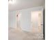Spacious bedroom with multiple doorways, soft carpeting, and neutral paint to accommodate different styles at 150 W Morehouse Ave, Mooresville, NC 28117