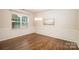 Inviting dining room featuring wainscoting, wood floors, a modern chandelier, and large windows at 150 W Morehouse Ave, Mooresville, NC 28117
