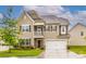 Charming two-story home with a welcoming front porch, manicured lawn, and attached two-car garage at 150 W Morehouse Ave, Mooresville, NC 28117
