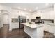 Bright kitchen featuring granite countertops, a large island, stainless appliances, and white cabinets at 150 W Morehouse Ave, Mooresville, NC 28117