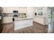 Spacious kitchen with granite countertops, stainless appliances, island, and white cabinetry at 150 W Morehouse Ave, Mooresville, NC 28117