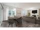Bright living room featuring a dining area, fireplace, neutral decor, and lots of natural light at 150 W Morehouse Ave, Mooresville, NC 28117