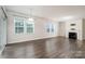 Spacious living room with wood floors, gas fireplace, and sliding glass doors to the backyard at 150 W Morehouse Ave, Mooresville, NC 28117