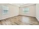 Well-lit bedroom with neutral walls, hardwood floors, and windows at 1540 Croydon St, Indian Land, SC 29707