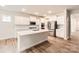 Modern kitchen with stainless steel appliances, white cabinets, an island, and hardwood floors at 1540 Croydon St, Indian Land, SC 29707